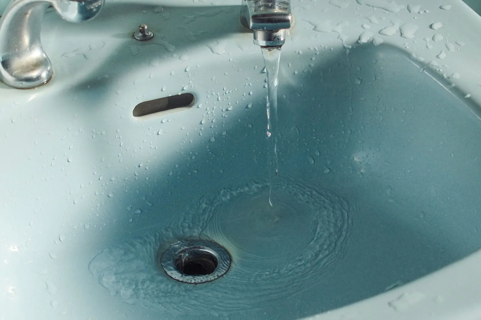 Bonde métallique d’un évier dans lequel l’eau stagne au lieu de s’écouler